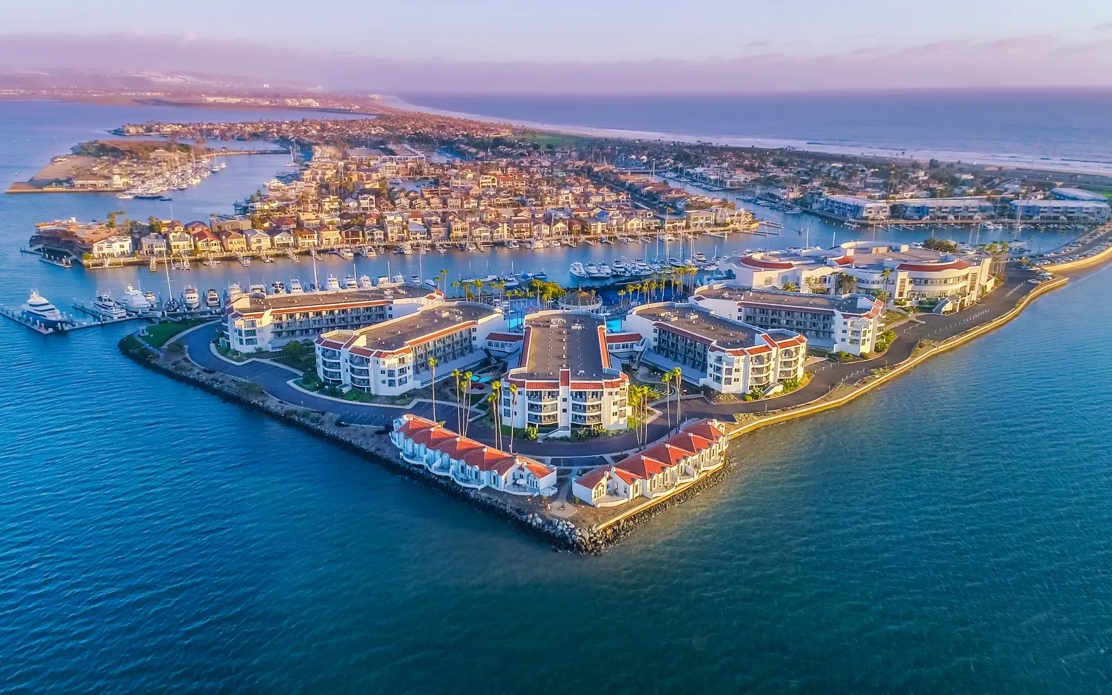 Loews Coronado Bay's private peninsula at golden hour, seen from above.